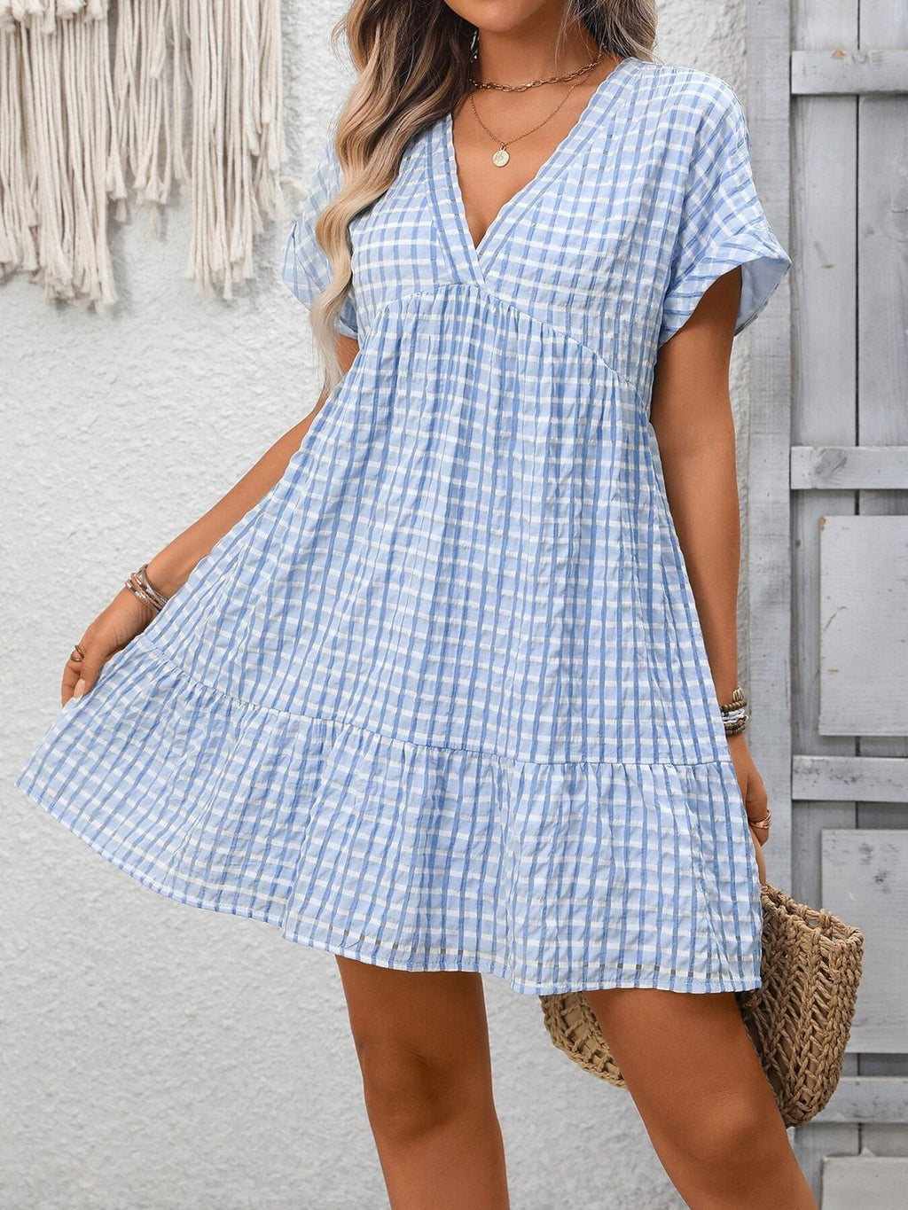 Lightweight plaid V-neck mini dress with ruffle hem from Trendsi, perfect for seasonal fashion and casual wear.