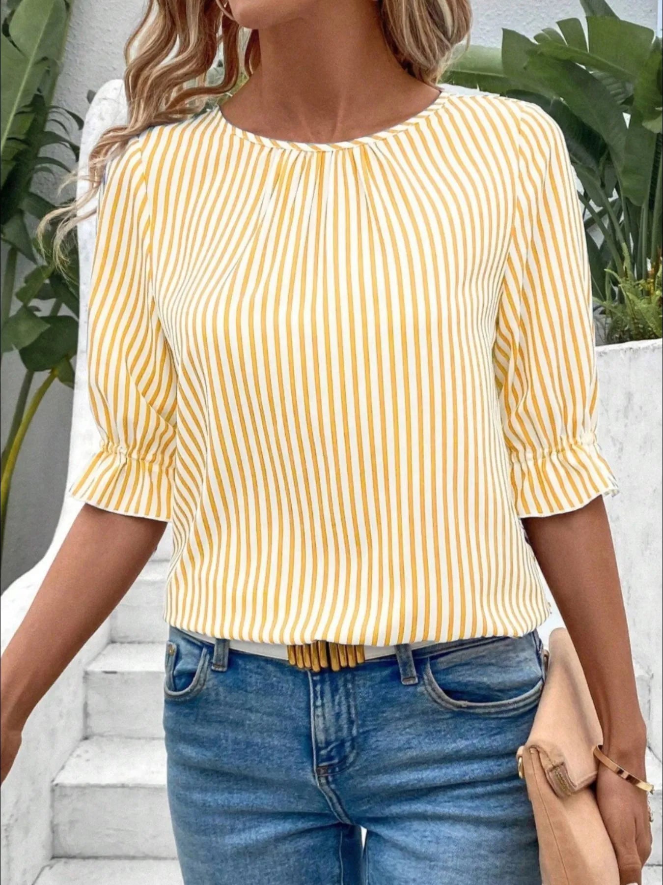 Women's striped ruffled round neck half sleeve blouse by Trendsi, showing a stylish top with ruffle details and a round neckline.