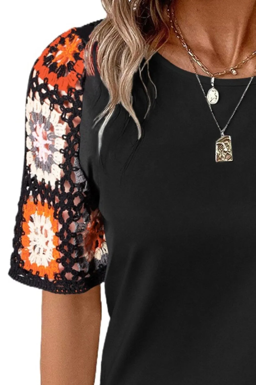 Geometric print round neck short sleeve blouse from Trendsi, stylish tops with vibrant geometric patterns and comfortable fit.