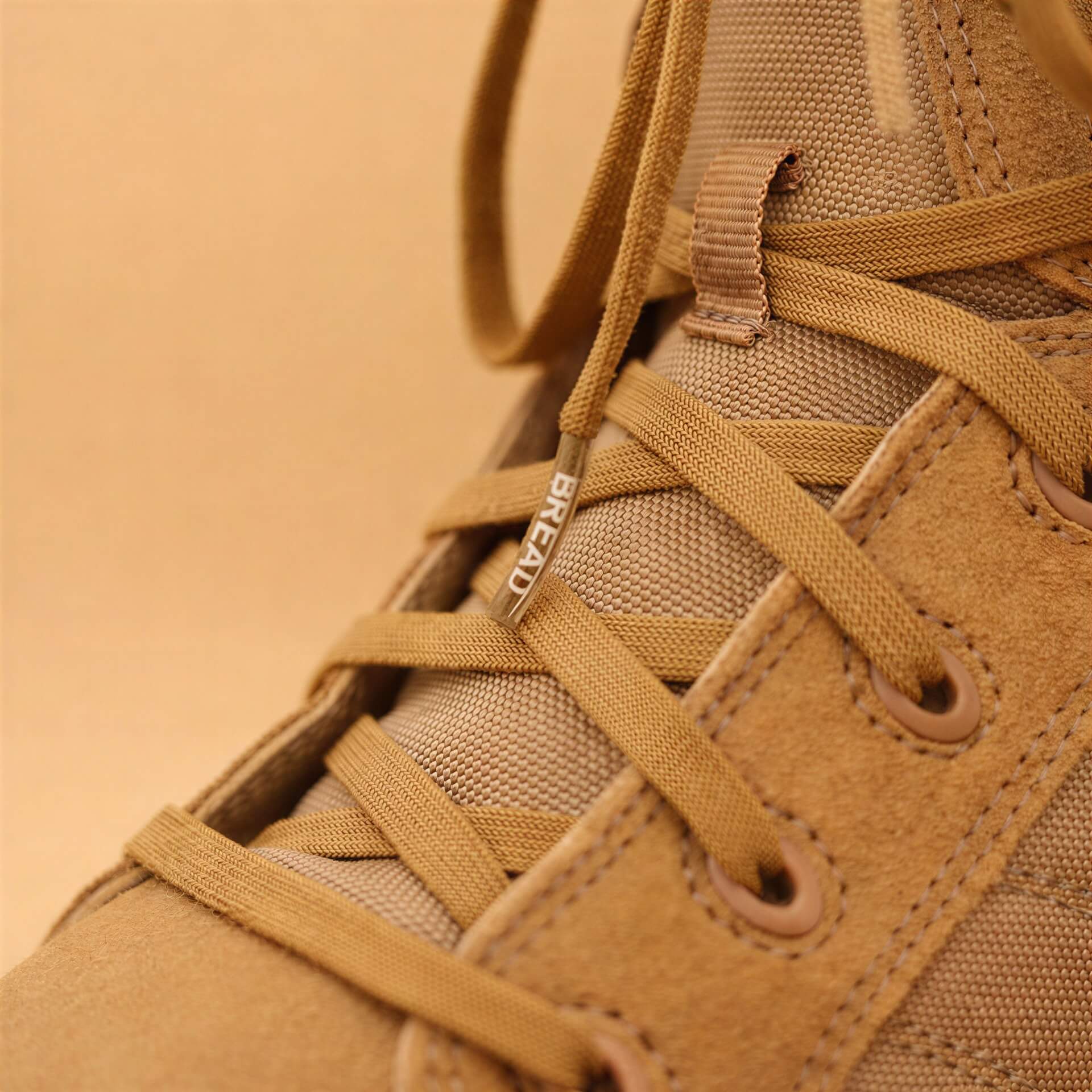 Coyote brown elastic shoelace by Bread, stretchy and durable, designed for comfortable, secure fit on casual or athletic shoes.
