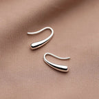 Elegant minimalist drop earrings in lightweight sterling silver jewelry for women, featuring simple, sleek design.