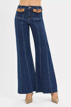 High-rise wide flare jeans with leather pocket details, stylish denim pants from Trendsi, shown on a model.