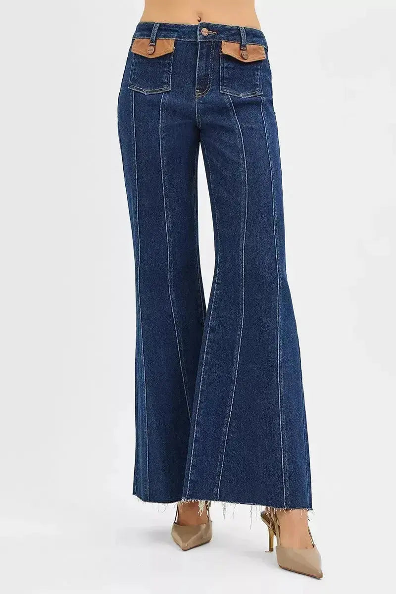 High-rise wide flare jeans with leather pocket details by Trendsi, showcasing stylish denim with unique leather accents and a flattering fit.