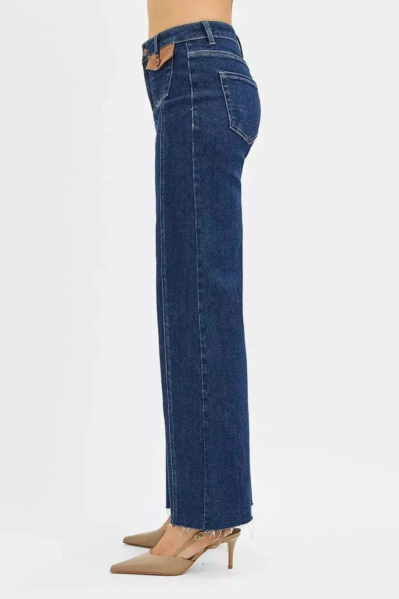 High-rise wide flare jeans by Trendsi featuring leather pocket details and a stylish, form-fitting silhouette.