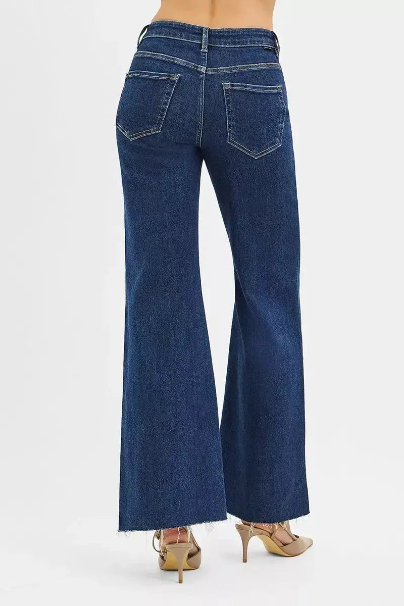 High-rise wide flare jeans with leather pocket details by Trendsi, showcasing the stylish denim design and unique pocket accents.