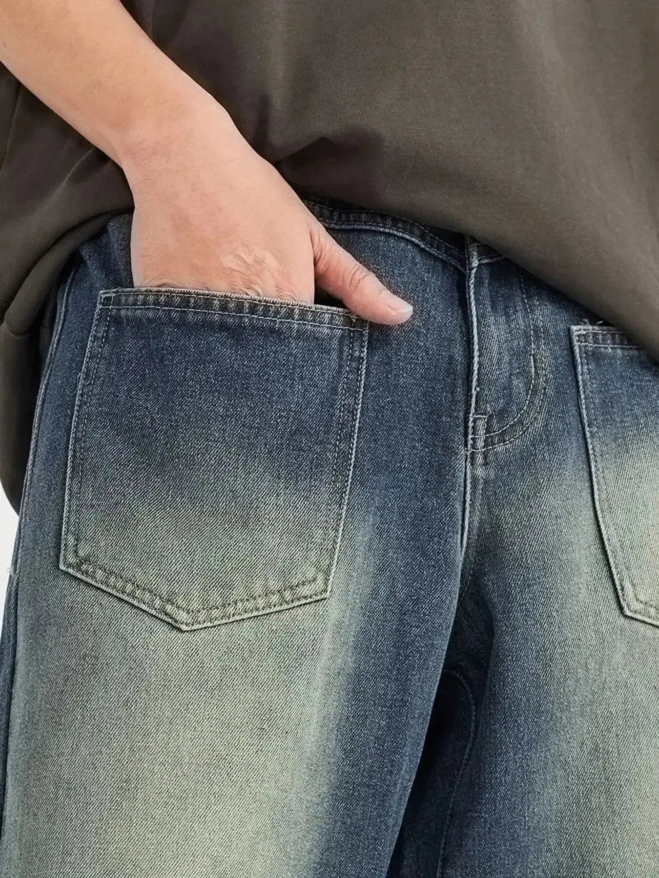 Men's vintage wash wide-leg denim jeans by Trendsi with relaxed fit, cotton construction, and classic denim style.