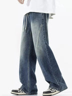 Men's vintage wash wide-leg drawstring jeans with relaxed fit made of cotton denim, featuring classic denim texture and casual style.