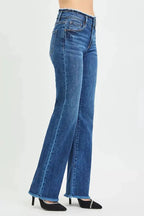 Mid-rise bootcut jeans with frayed waist and raw hem detail, featuring classic denim fabric and trendy distressed accents.
