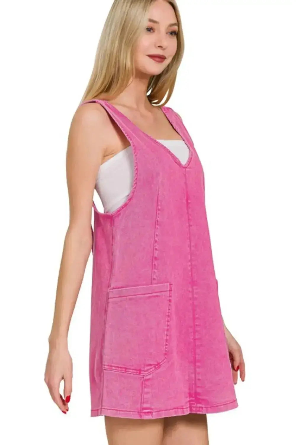 Pink washed denim overall dress with adjustable straps, trendy denim fashion by Trendsi, shown on a model.