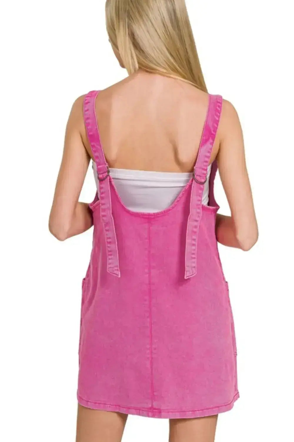 Pink washed denim overall dress with adjustable straps, casual denim style from Trendsi, shown on a model.