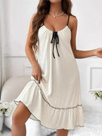 Plus size tiered ruffled lounge dress with contrast trim, cozy pajama loungewear by Trendsi, shown on a model.