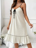Plus size tiered ruffled lounge dress with contrast trim, cozy pajama loungewear from Trendsi, featuring soft fabric and relaxed fit.