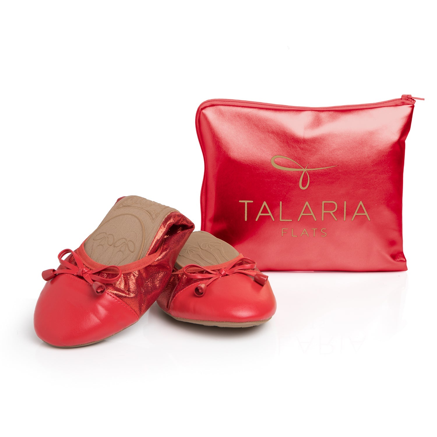 Metallic ruby red ballet flats with bows and matching Talaria logo travel pouch on a white background.