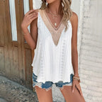 White eyelet sleeveless top with a beige crochet V-neckline, paired with distressed denim shorts.
