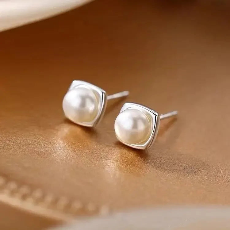 Minimalist 925 sterling silver pearl stud earrings with geometric design, elegant jewelry for women.