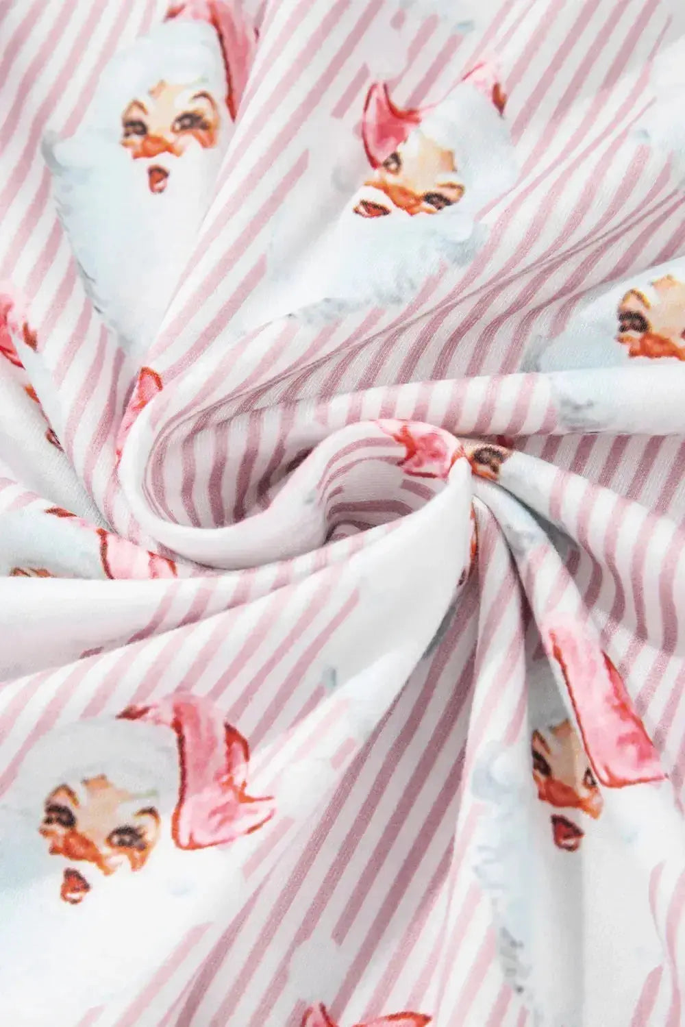 Women's festive Santa print long sleeve pajamas lounge set by Trendsi, featuring cozy holiday-themed pajama top and bottoms.