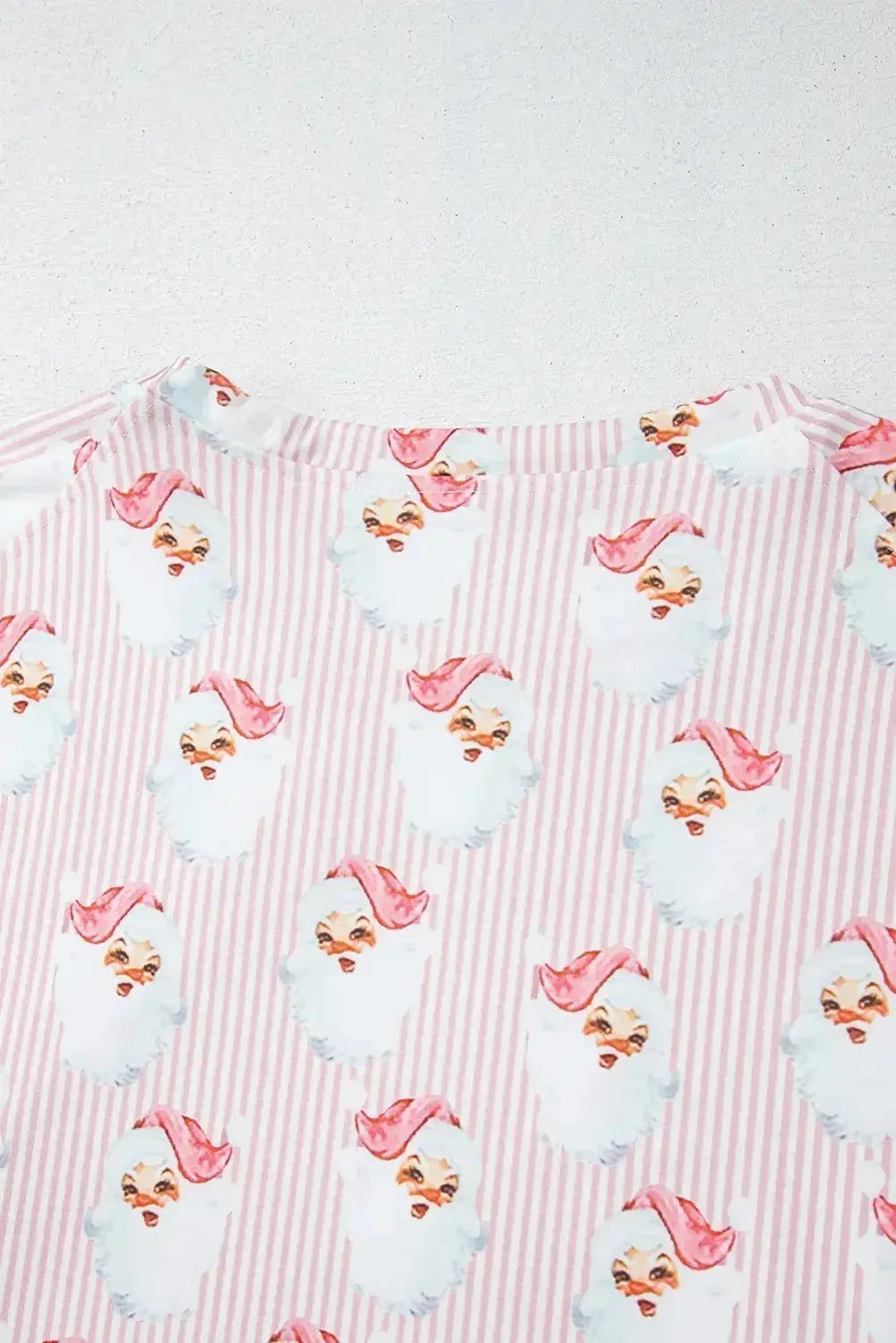 Women's festive Santa print long sleeve pajama lounge set by Trendsi, featuring cozy holiday-themed sleepwear with red and white Santa design.