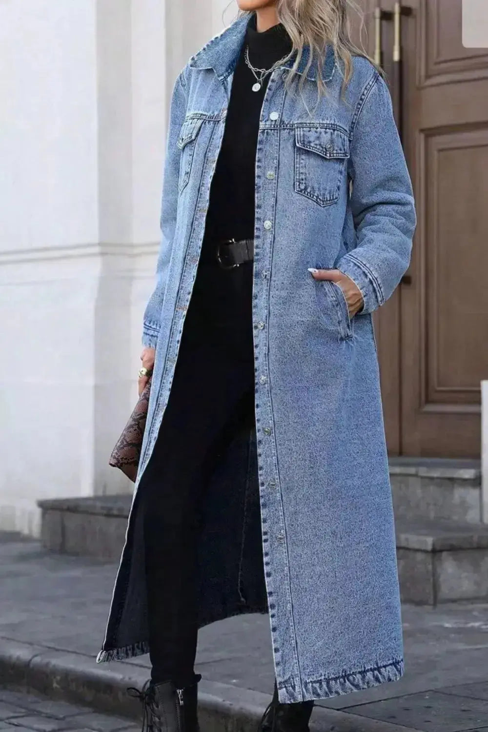Women’s longline denim jacket with button-down front, oversized fit, cotton fabric, and utility style for casual wear.