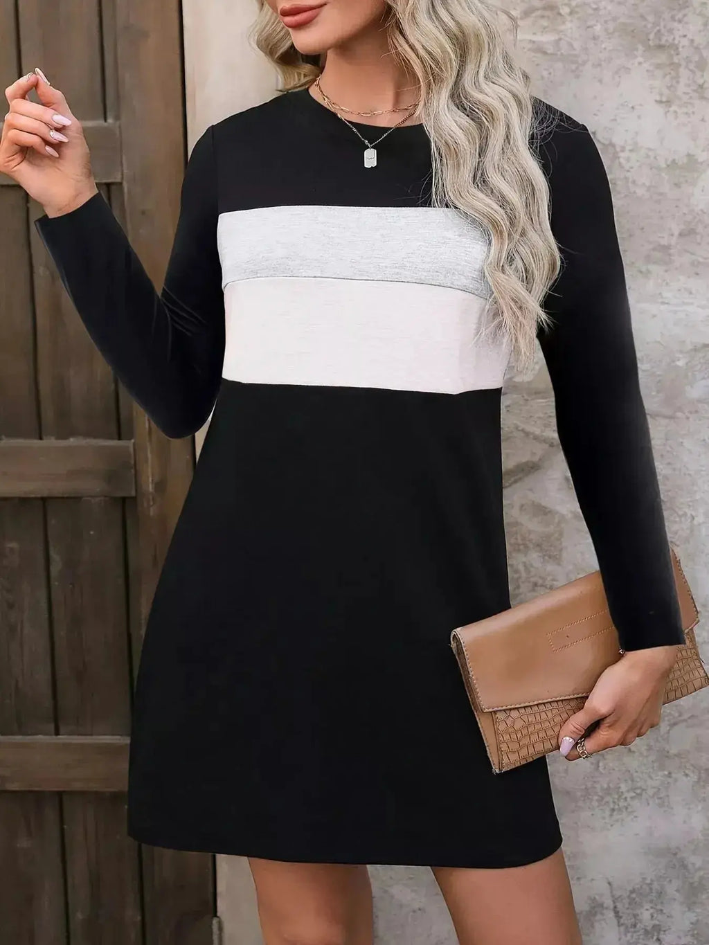 Plus size women's color block long sleeve casual mini dress by Trendsi, featuring a stylish color block design and relaxed fit.