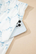 Women's printed round neck lounge set by Trendsi with soft pajama top and matching shorts, ideal for comfortable home wear.