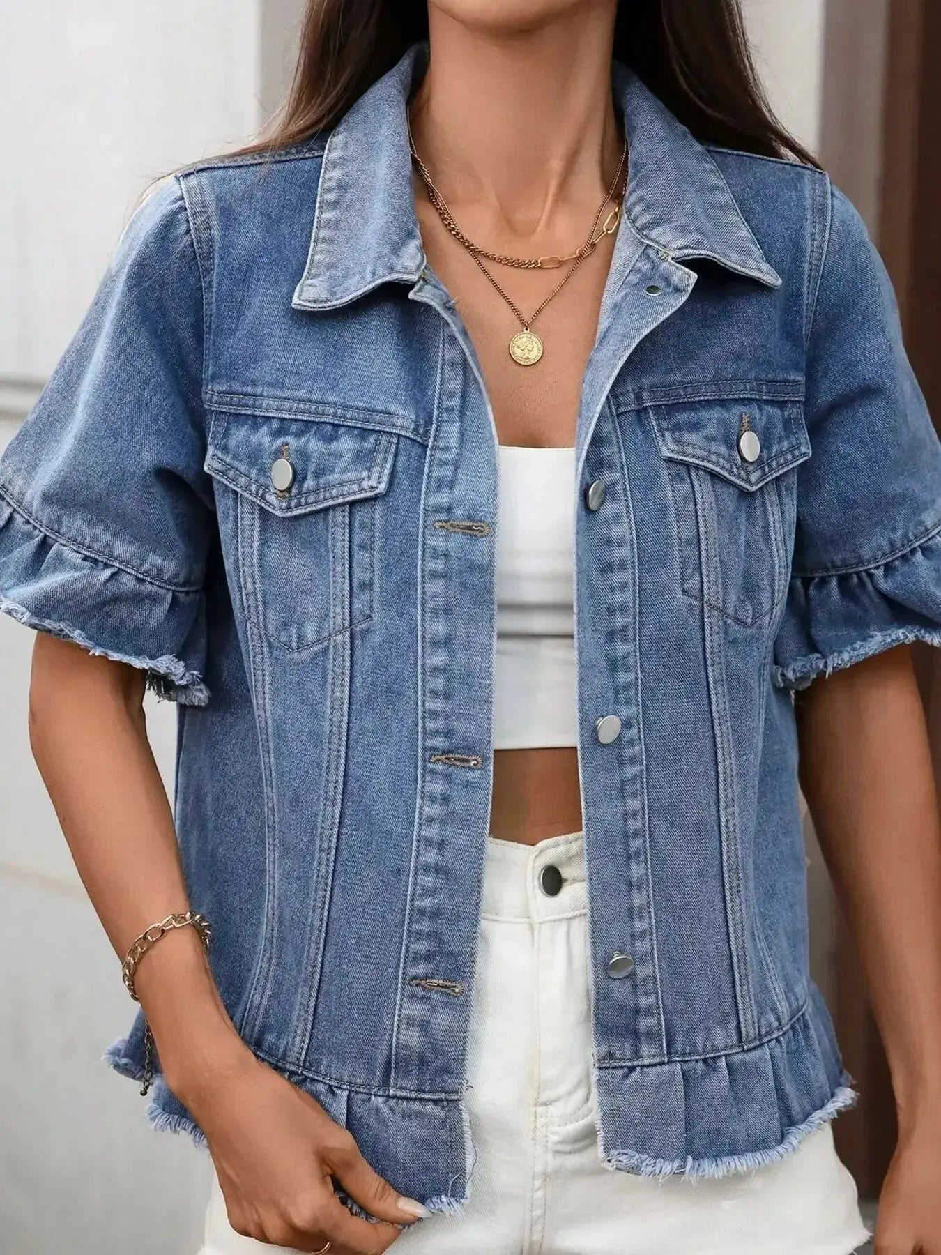 Women's raw hem ruffled denim jacket by Trendsi, stylish button-up jean jacket featuring distressed details and ruffle accents.