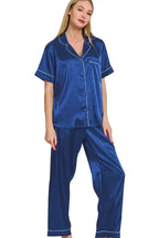 Women’s royal blue satin pajama set with short sleeves and button-down top by Trendsi, shown laid out on a surface.