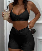 Women’s ruched sports bra and high-waisted shorts matching activewear set by Trendsi, featuring comfortable, stylish workout clothing.