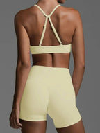 Women wearing a trendy ruched sports bra and high-waisted shorts activewear set by Trendsi, perfect for workout or casual wear.