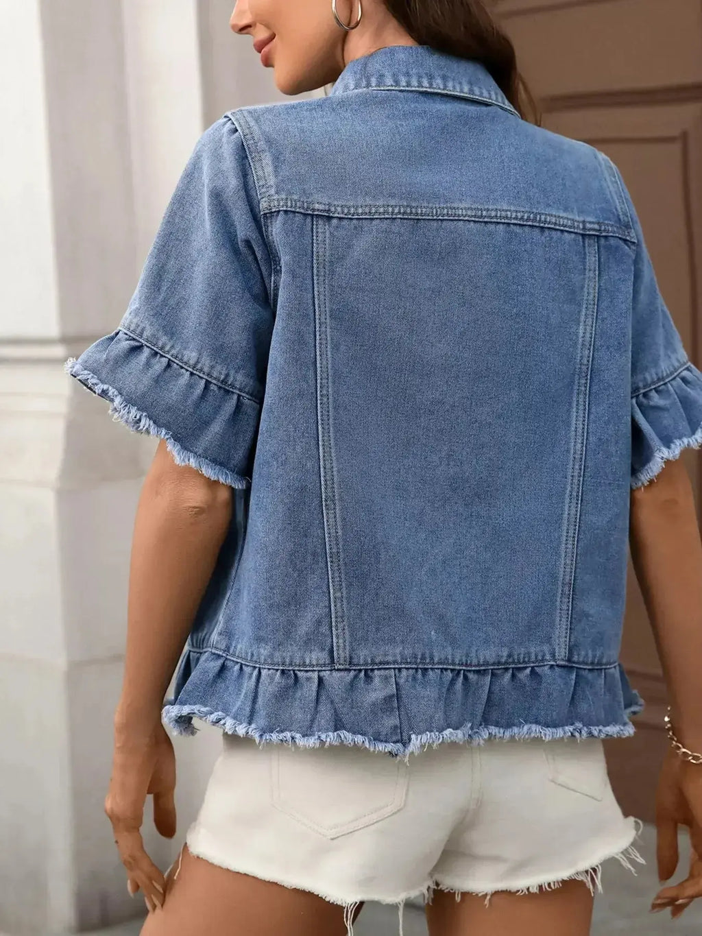 Women’s ruffled raw hem button-up denim jacket by Trendsi, featuring classic denim fabric with stylish ruffle details and a fitted silhouette