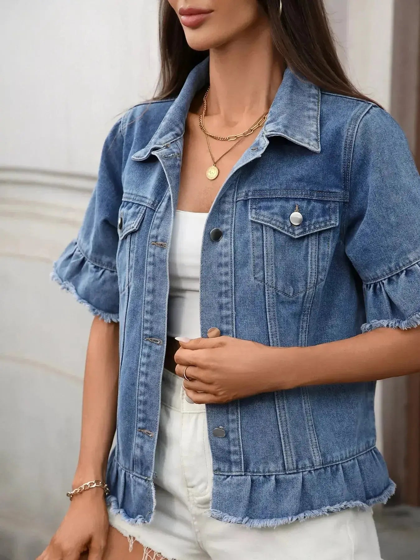 Women’s ruffled raw hem button-up denim jacket by Trendsi, featuring stylish ruffles and classic denim design.