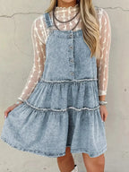 Women’s tiered flowy denim overall dress with raw hem, made of 100% cotton, featuring a relaxed fit and casual style.
