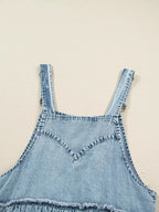 Women’s tiered, flowy denim overall dress with raw hem, made from 100% cotton, styled for casual summer wear.