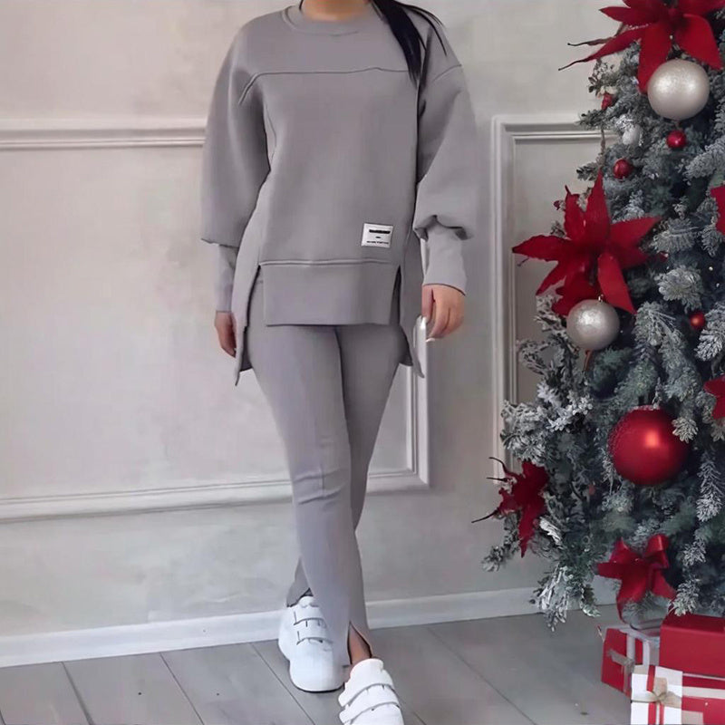 Women's solid color 2-piece casualwear set by FitiqueFit, featuring a relaxed top and matching pants on a model.