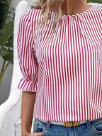 Women's striped ruffled round neck half sleeve blouse by Trendsi, featuring a stylish design and feminine ruffle details.