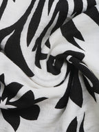Women's printed halter neck maxi dress with tie-back detail, flowing fabric and vibrant pattern, from Trendsi.