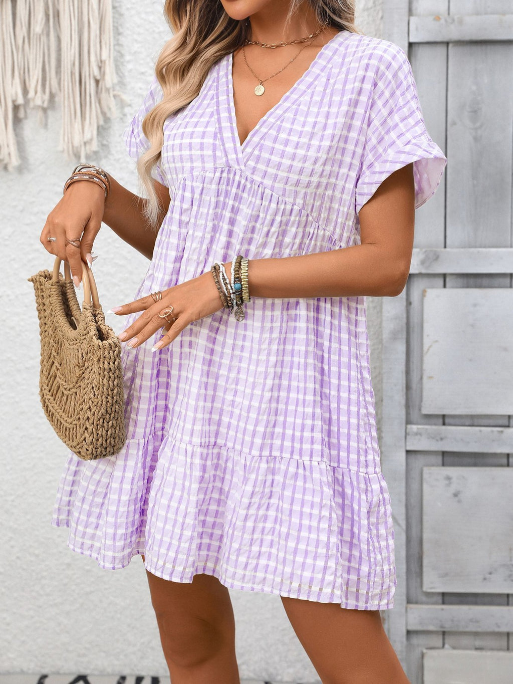Lightweight plaid V-neck mini dress with ruffle hem from Trendsi, perfect for seasonal fashion and casual wear.