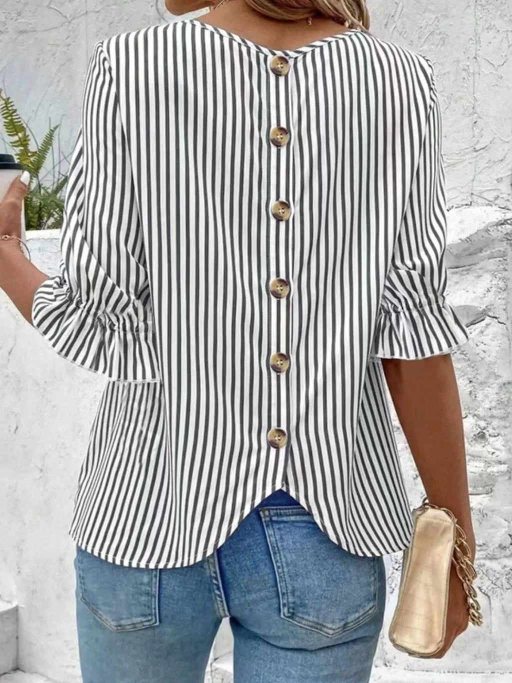 Women's striped ruffled round neck half sleeve blouse from Trendsi, showcasing a stylish design with ruffles and a round neckline.