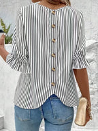 Women's striped ruffled round neck half sleeve blouse from Trendsi, showcasing a stylish design with ruffles and a round neckline.