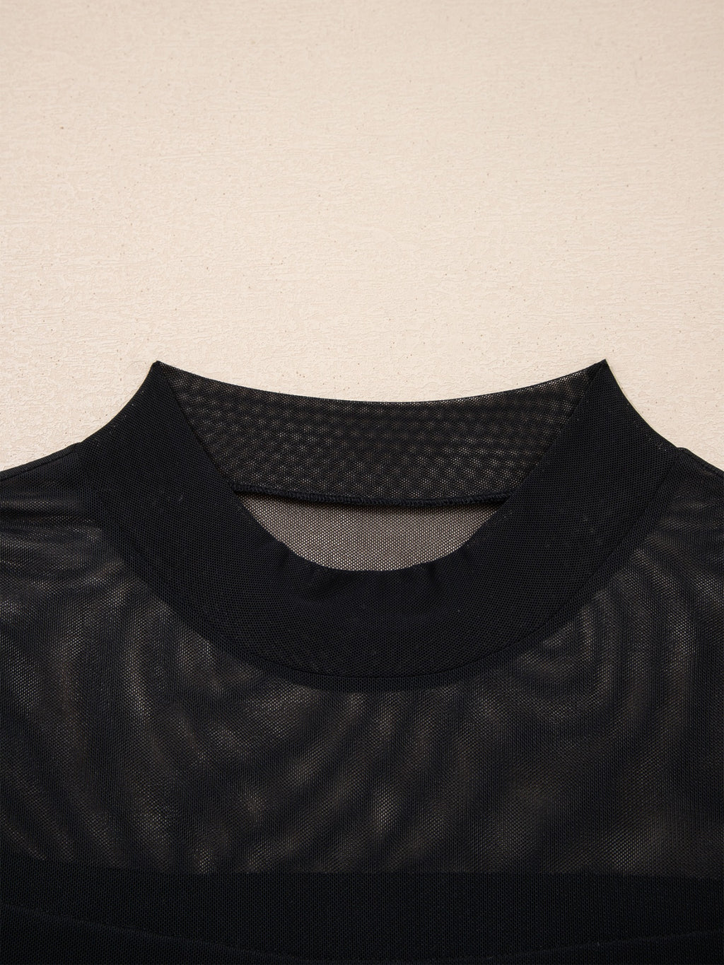 Women's sheer mesh patchwork cap sleeve T-shirt by Trendsi, featuring elegant layering style with see-through fabric and stylish design.