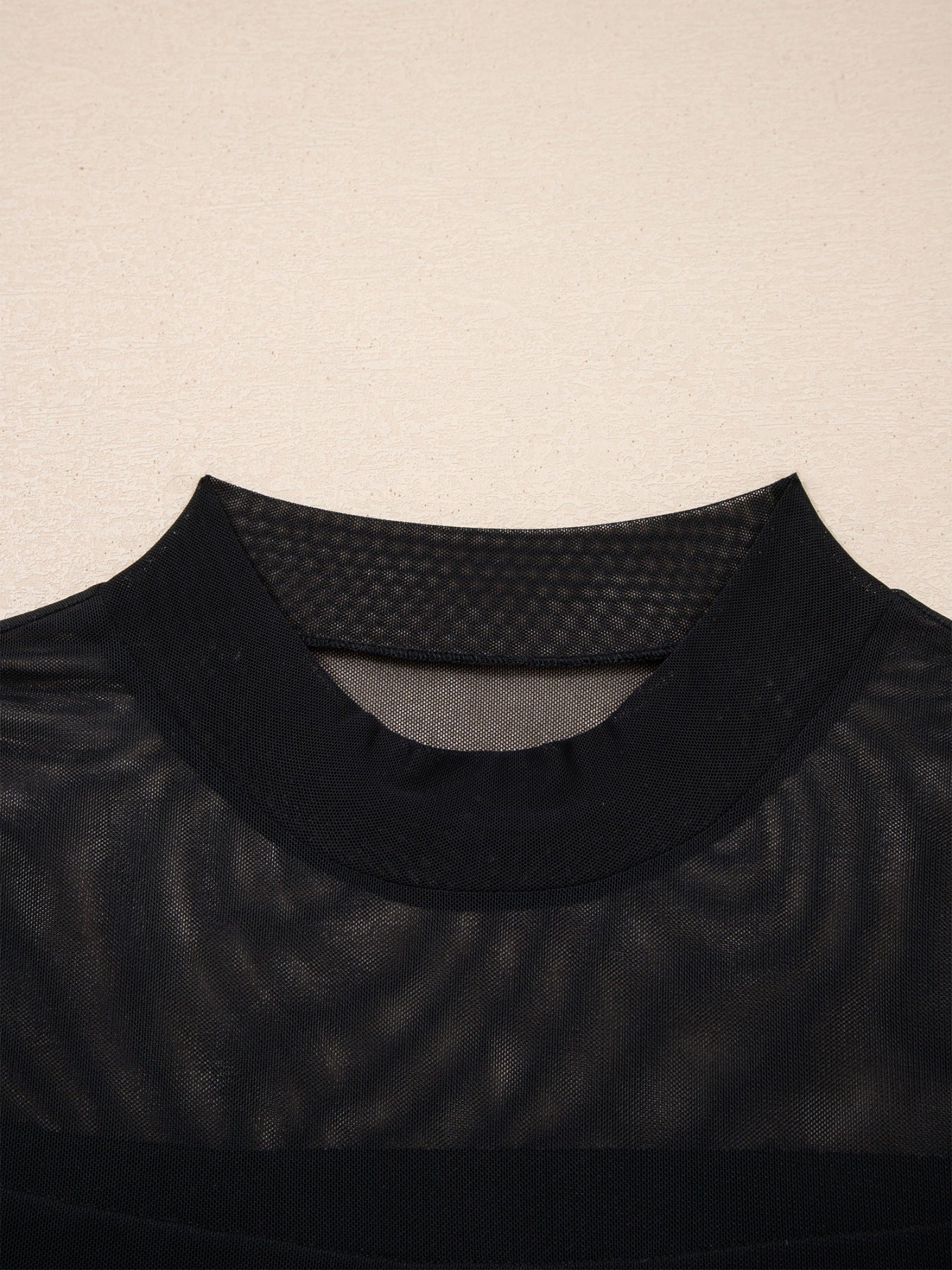 Women's sheer mesh patchwork cap sleeve T-shirt by Trendsi, featuring elegant layering style with see-through fabric and stylish design.