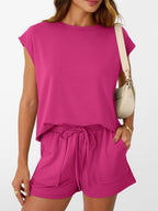 Women's soft round neck cap sleeve lounge set with drawstring shorts, stylish 2-piece set by Trendsi, shown on a model.