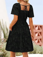 Women's smocked tiered square neck short sleeve casual dress with pockets, stylish and comfortable from Trendsi.