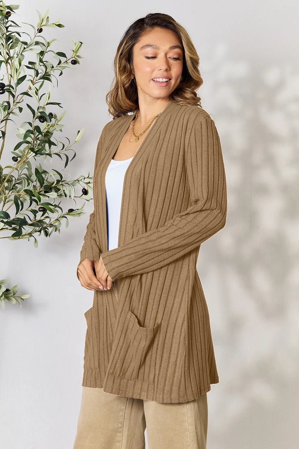 Women's ribbed open front cardigan with functional pockets, lightweight and cozy, in a neutral color, perfect for layering.