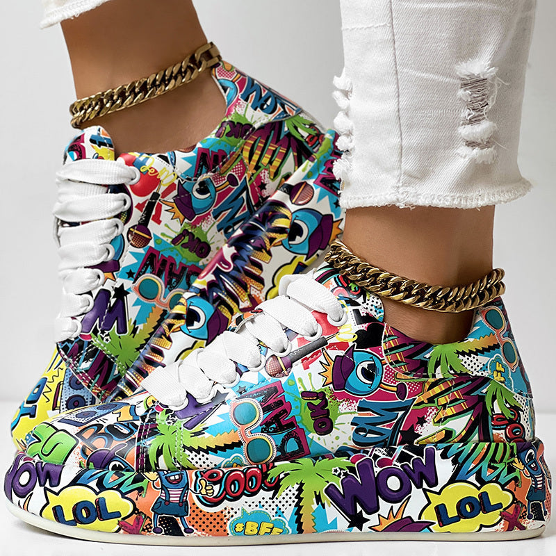 Low-top sneakers with a vibrant, multi-colored graffiti print, white laces, and chunky white soles.