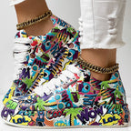 Low-top sneakers with a vibrant, multi-colored graffiti print, white laces, and chunky white soles.