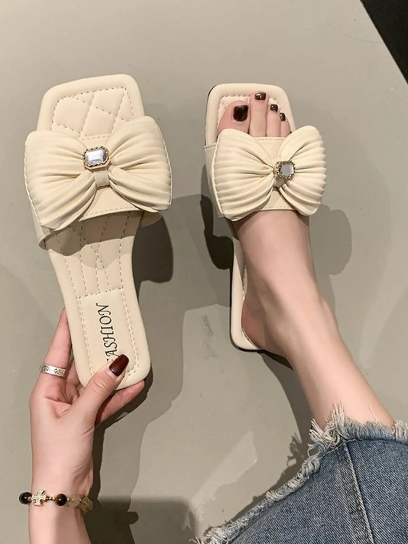 Women's elegant bow-knot faux leather flat sandals with ankle straps and open toe design, perfect for summer wear.