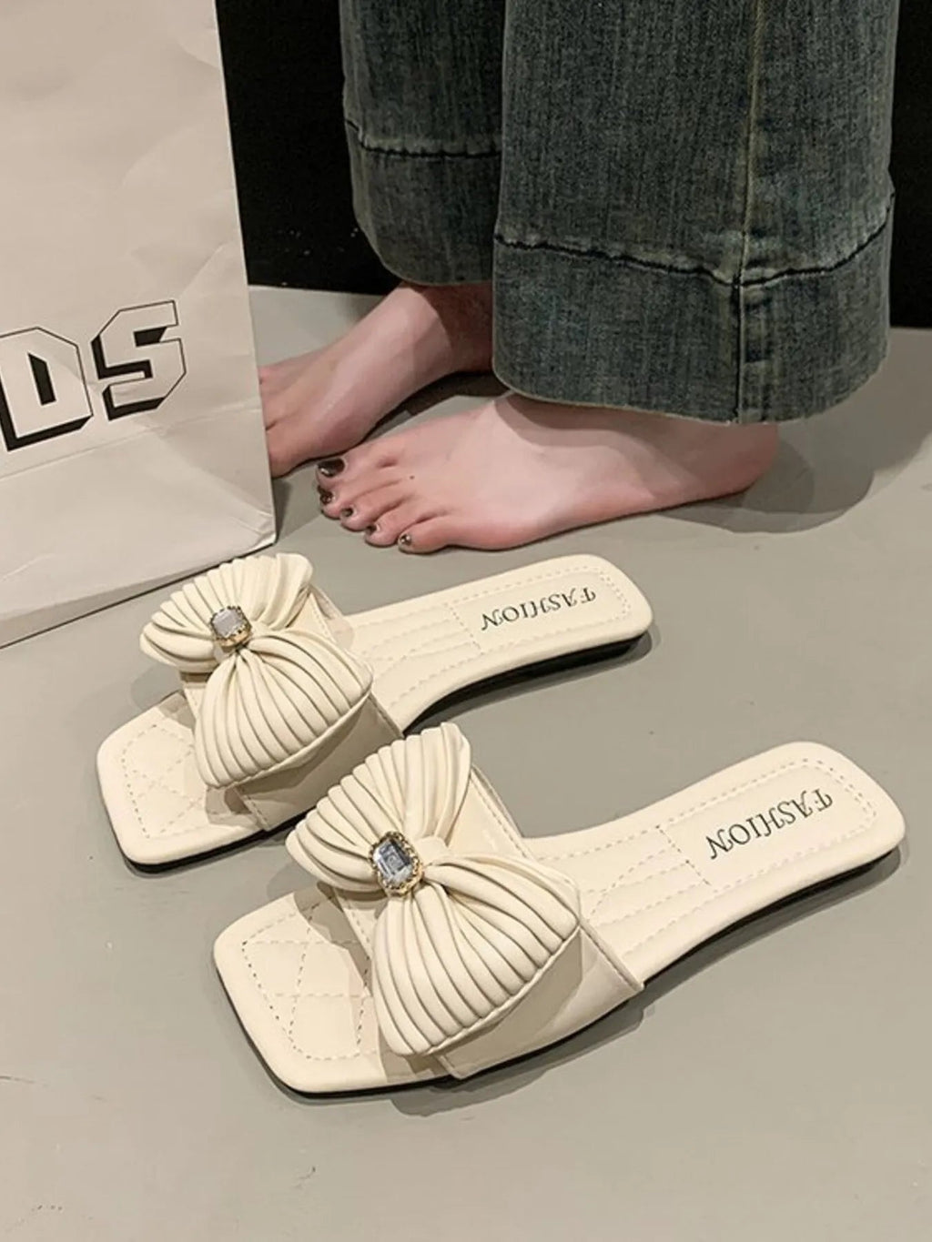 Women's elegant bow-knot faux leather flat sandals with ankle straps, featuring a stylish design and comfortable flat sole.