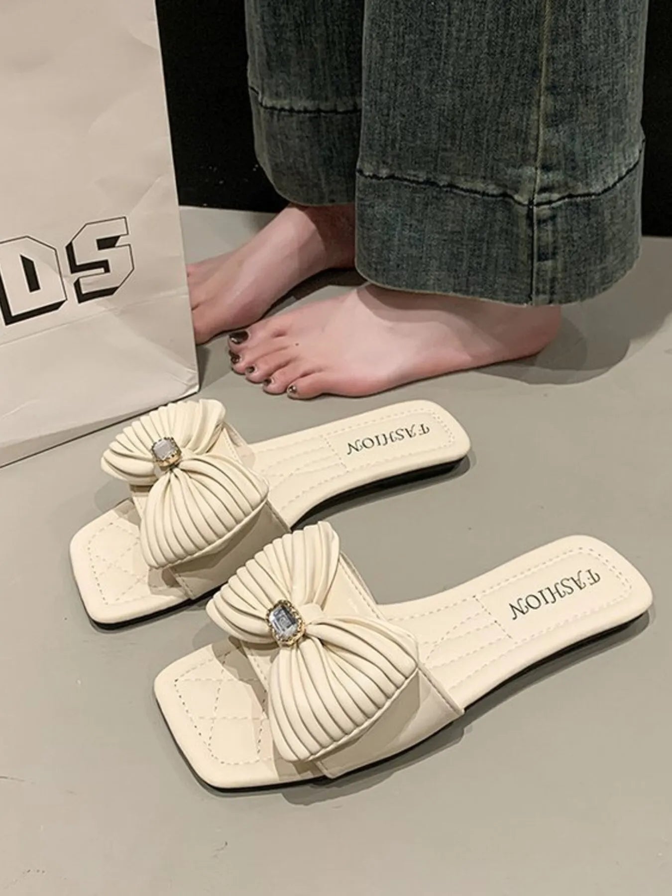 Women's elegant bow-knot faux leather flat sandals with ankle straps, featuring a stylish design and comfortable flat sole.