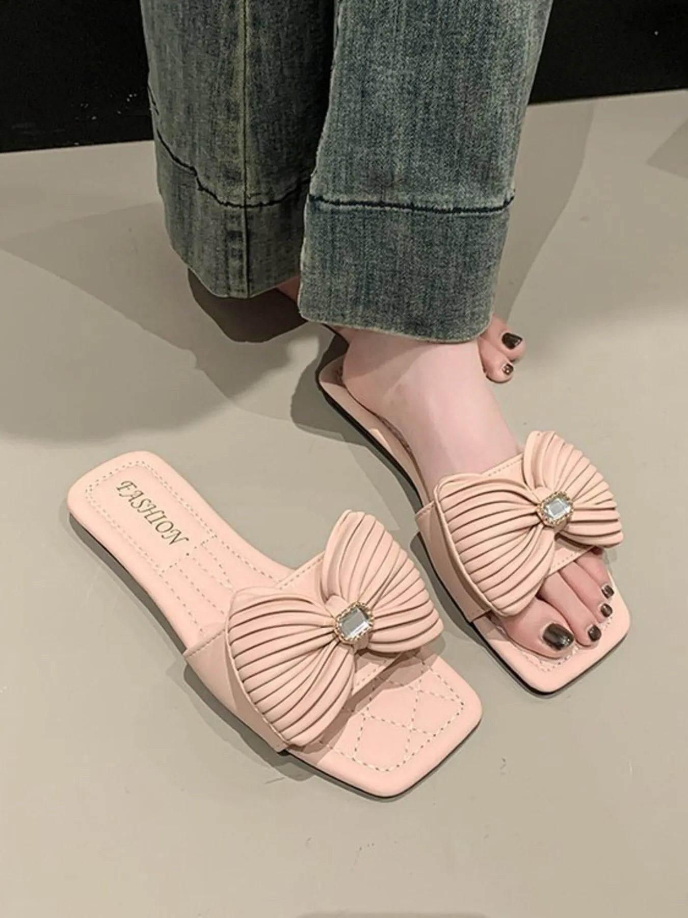 Women's elegant bow-knot faux leather flat sandals with open toes and ankle straps, designed by Trendsi.