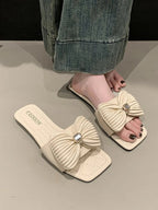 Women's elegant faux leather flat sandals with bow-knot detail, stylish and comfortable shoe from Trendsi.